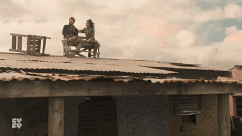two people on a roof on the porch