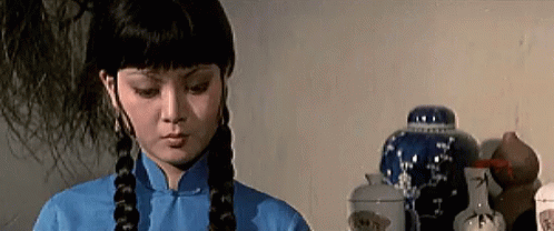 an asian woman is wearing her hair pulled in the ponytail