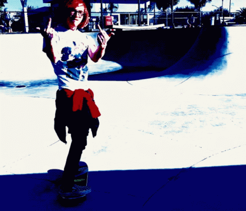 a skateboarder balancing on a red and white ground