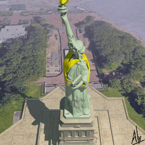 the statue has a very tall green bird on its finger