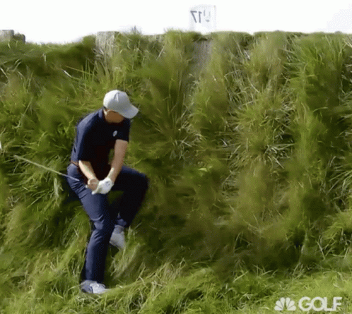 a man on top of the grass with golf club