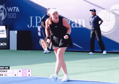 a woman in a black top is playing tennis