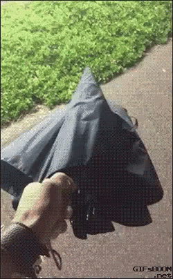 a person is holding an open umbrella in the street