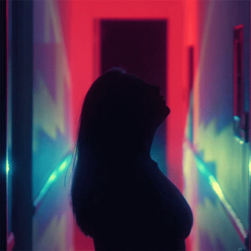 an image of a woman in the dark with lights