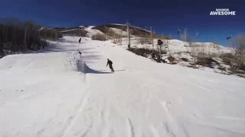 someone riding skis on top of a snowy mountain