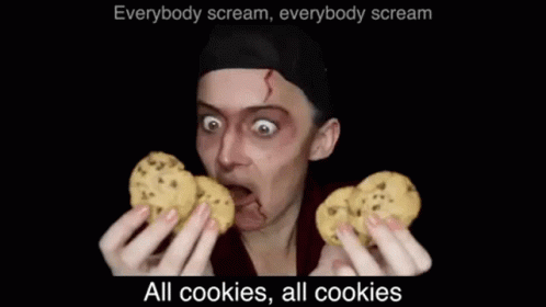 an animated image of a man with dark blue eyes, making a funny face and holding a cookie