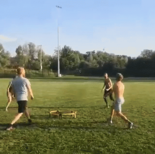 some men playing tug ropes on a soccer field