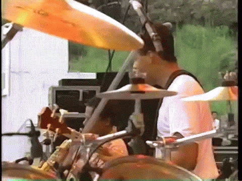 a boy on stage drumming and playing the drums