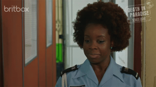 a woman with dark skin and blue eyes wearing an uniform