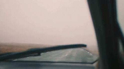 a car's windshield in a blurry view as it travels