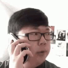 a man talking on a phone while holding a phone