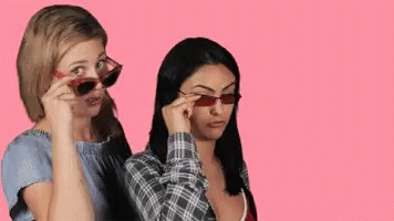 two girls have their eyes shaded by sunglasses