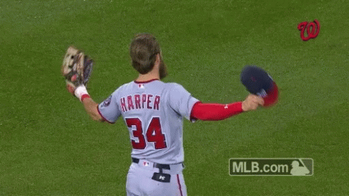 a baseball player with blue gloves throws a ball