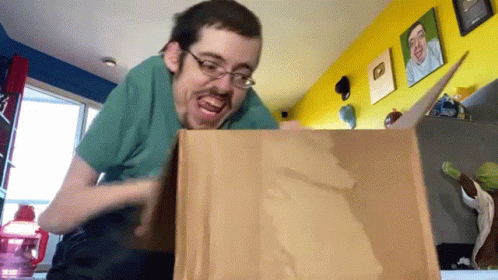 a man is opening a giant pizza box