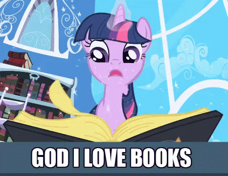 a little pony sitting in front of an open book