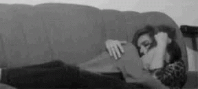 a man sitting on top of a sofa next to a woman