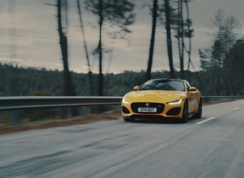a sports car is traveling down the road