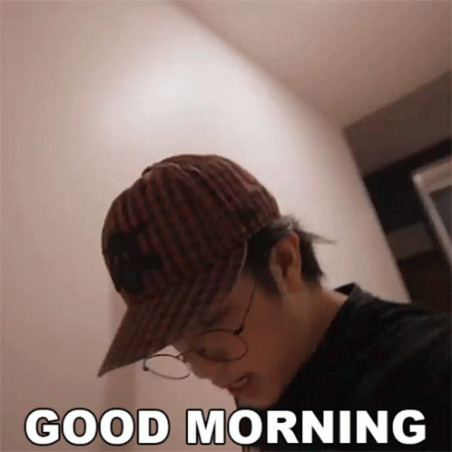 a man in hat and glasses is texting good morning