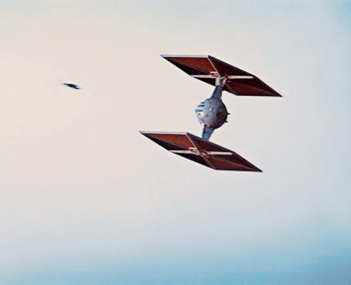 two birds are flying above some small square kites