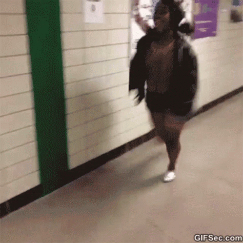 an image of a woman walking through the hallway