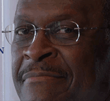 a black man is wearing glasses and staring at the camera