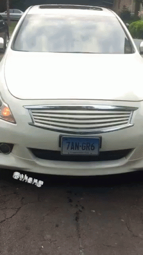 a white sports car with the license plate on