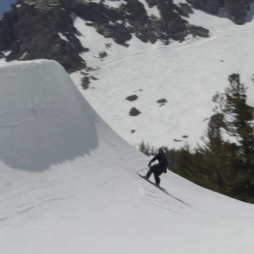 someone skiing down a steep slope in the snow