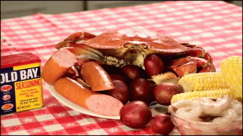 a purple table topped with blue crabs and marshmallows