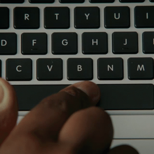 someones fingers are touching the keyboard of their computer