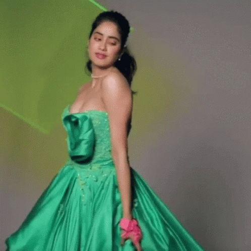 a woman in a green dress standing up
