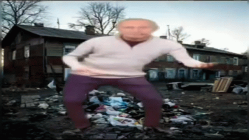 a man is standing on the garbage with a blue head