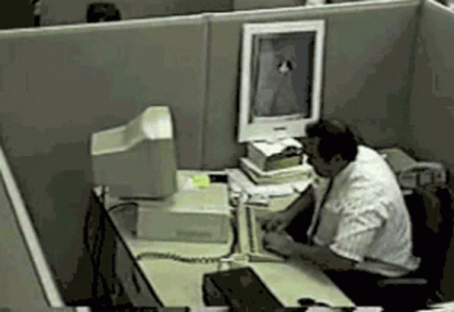 a man working on his computer in an office