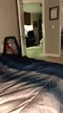 blurry po of an unmade bed and a view of a mirror