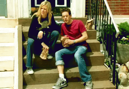 two people sitting on steps near the stairs