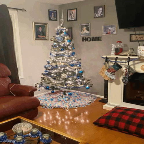 a blue couch in front of a decorated christmas tree