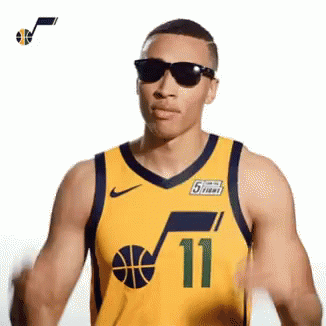 a person with a blue uniform, sunglasses and basketball ball