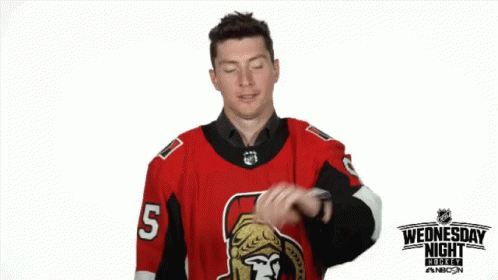 a man wearing a jersey pointing at soing