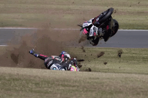a motorcycle rider crashes in the mud on his bike