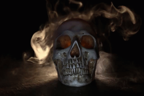 a burning skull with blue eyes on black table