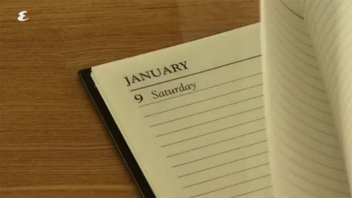 a calendar book and pen next to an empty notebook