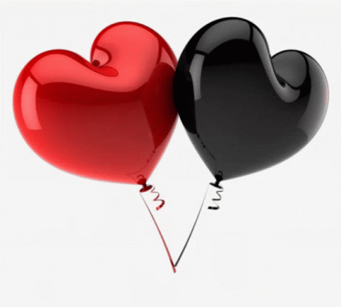 two heart shaped balloons floating together on a string