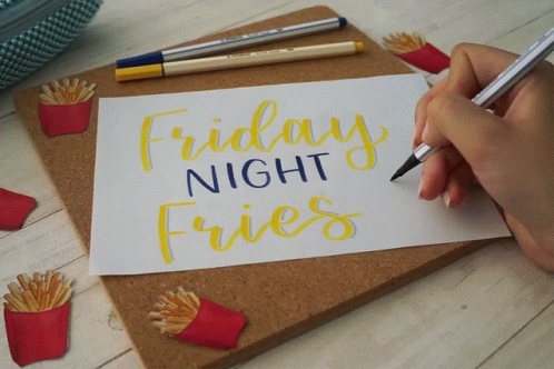 a man's hand writing friday night fries
