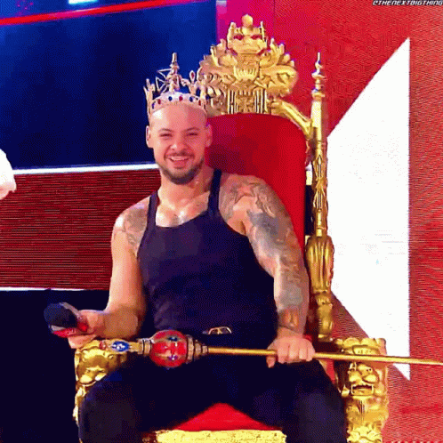 a man with a crown on top sitting in a throne