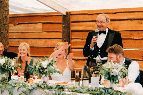 an image of a groom giving a speech to his bride