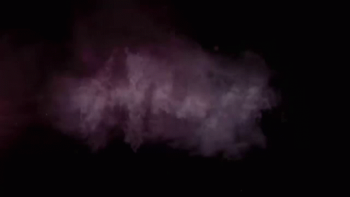 an airplane being driven by smoke on a dark background