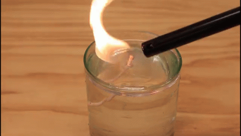 a spoon in a jar filled with water