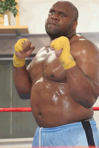 an overweight man is standing in his wrestling stance