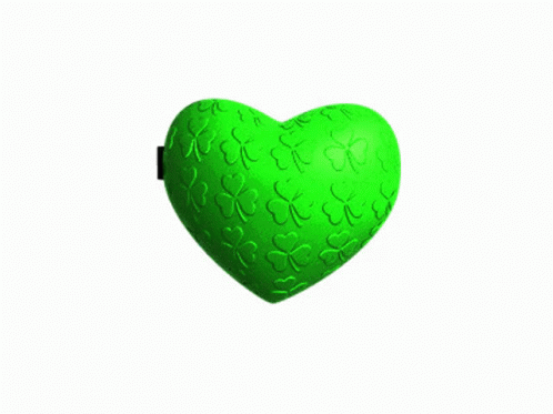 a green heart shaped toy, with small hearts in the middle