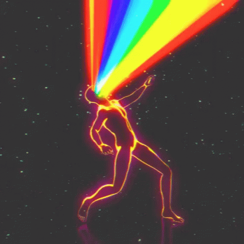 a person standing under a rainbow colored light