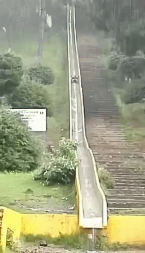a very long train going over a narrow track